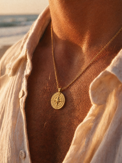 18K gold-plated compass pendant necklace worn on a man's chest, close-up of layered relief detail